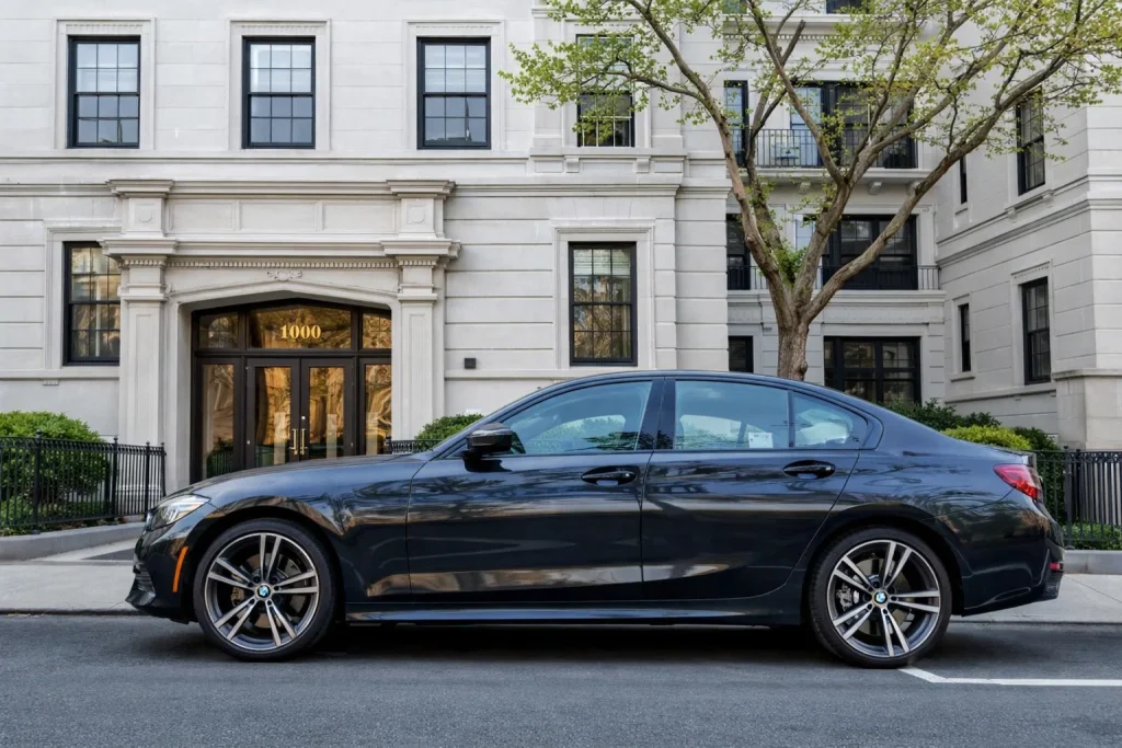 Executive black sedan staged at a quiet curb for a Redmond pickup