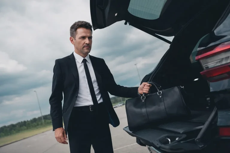 loading luggage into a black SUV