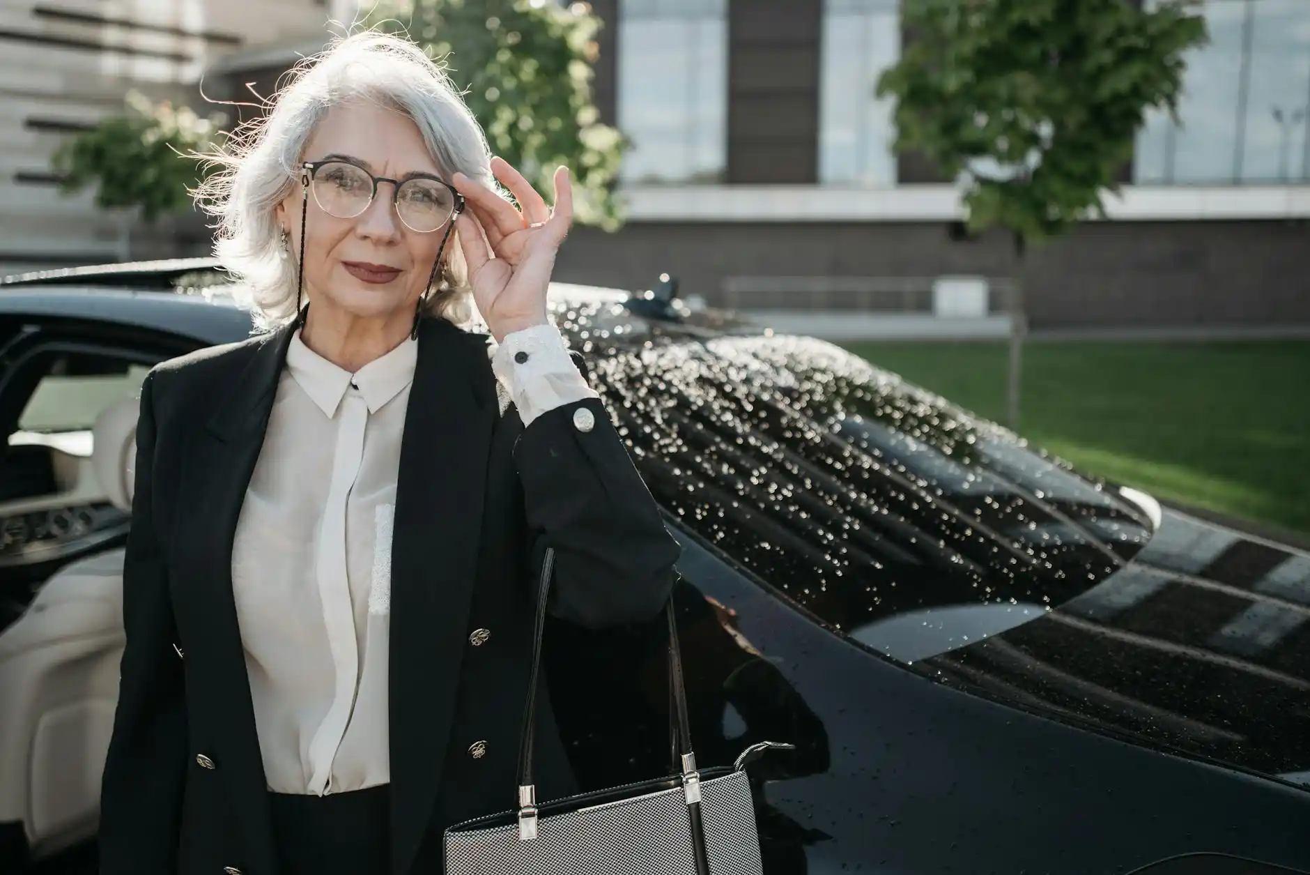 split scene showing a stressed traveler looking at a delayed ride app on a smartphone versus a calm passenger entering a polished black town car in downtown Seattle