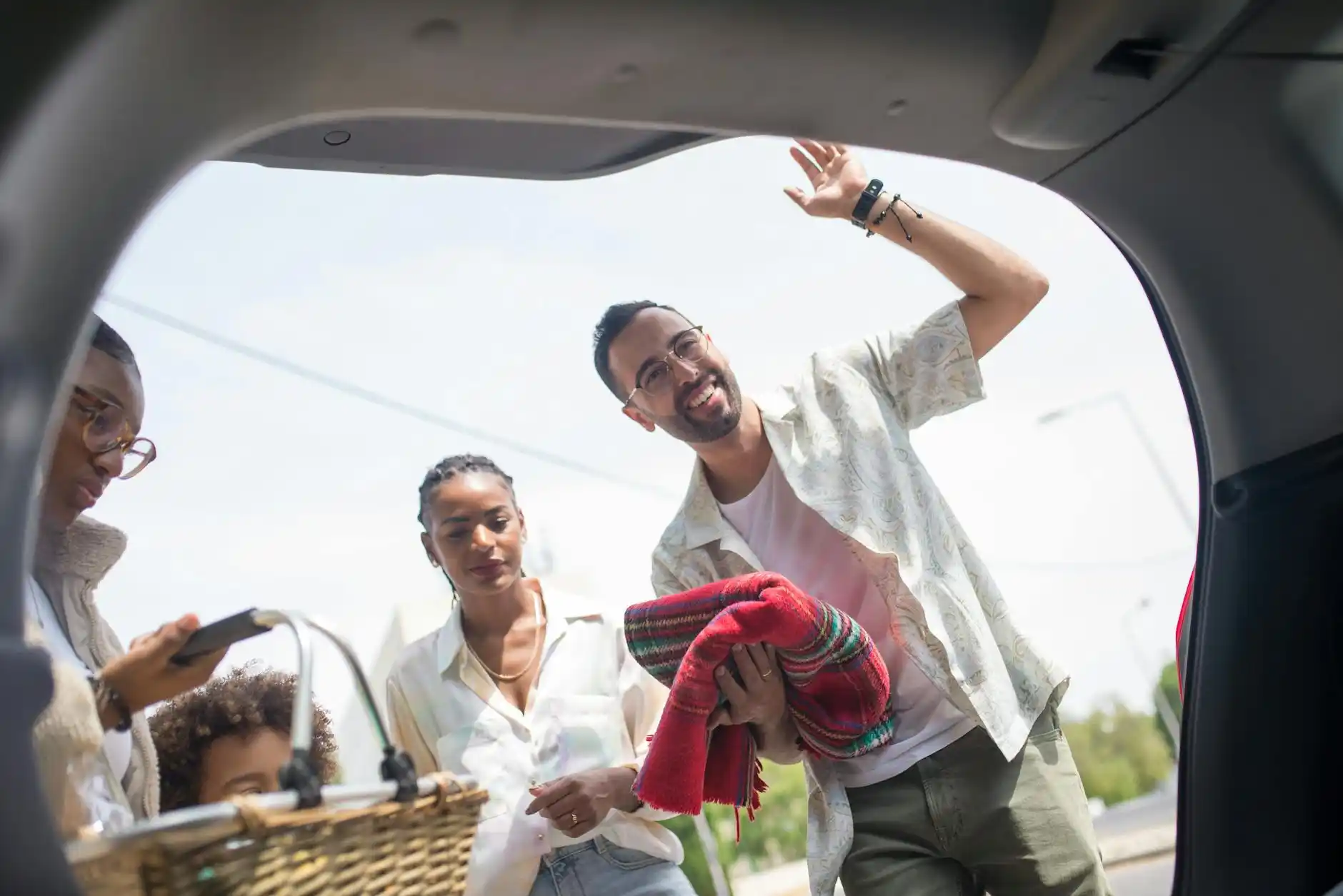 family of five with coordinated luggage loading into a spacious luxury SUV outside a Bellevue home, morning light, chauffeur in suit assisting with bags, children excited for va...