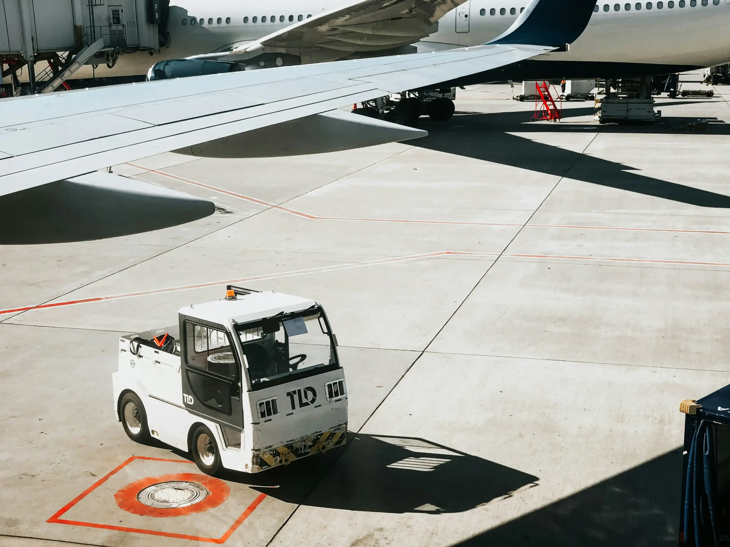organized group of travelers with matching suitcases loading into a spacious luxury shuttle near a Seattle townhouse, one parent securing a child's backpack, realistic candid tr...