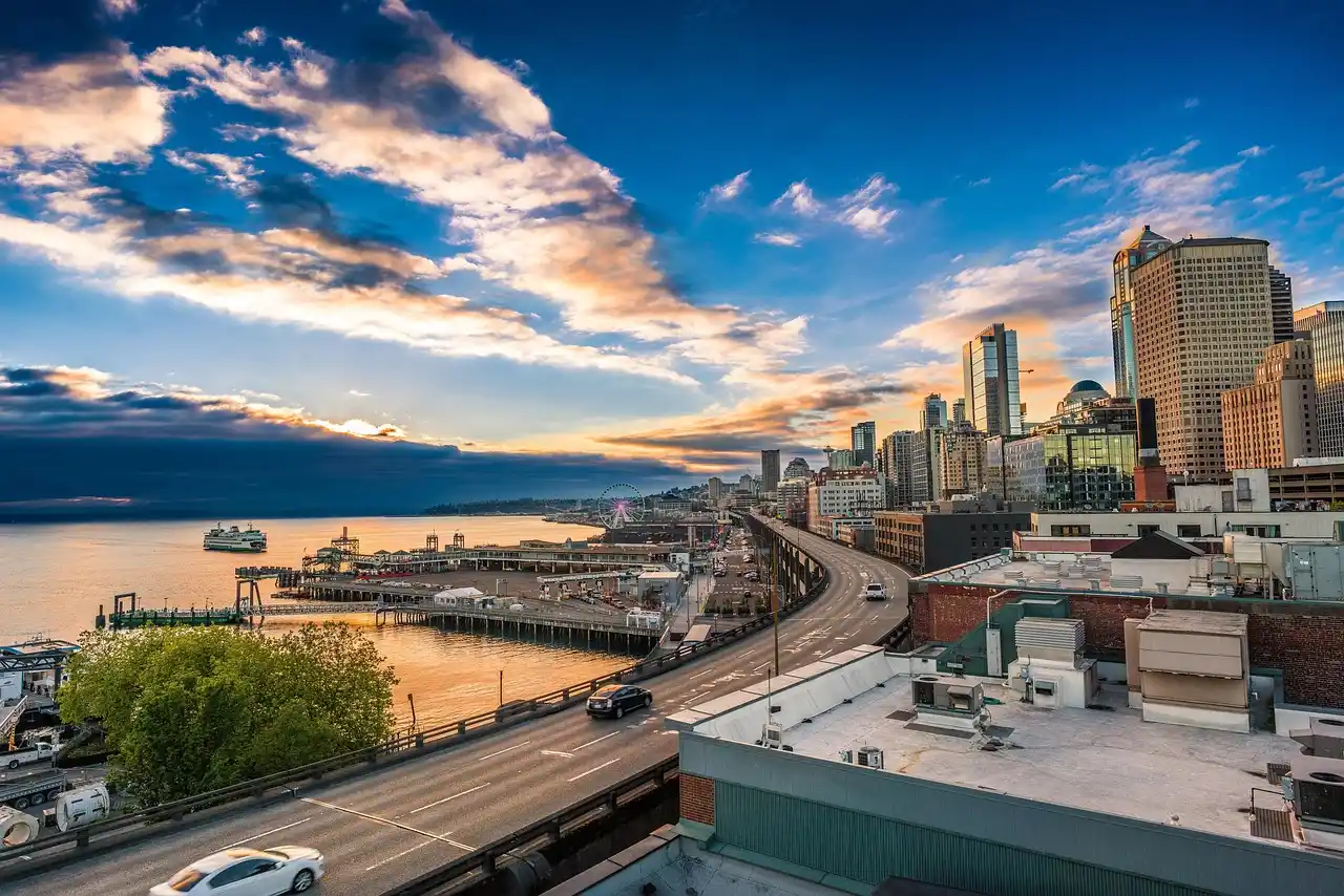 luxury town car outside a modern downtown Seattle office tower at dusk, executive traveler with rolling luggage entering vehicle, city lights reflecting on wet pavement