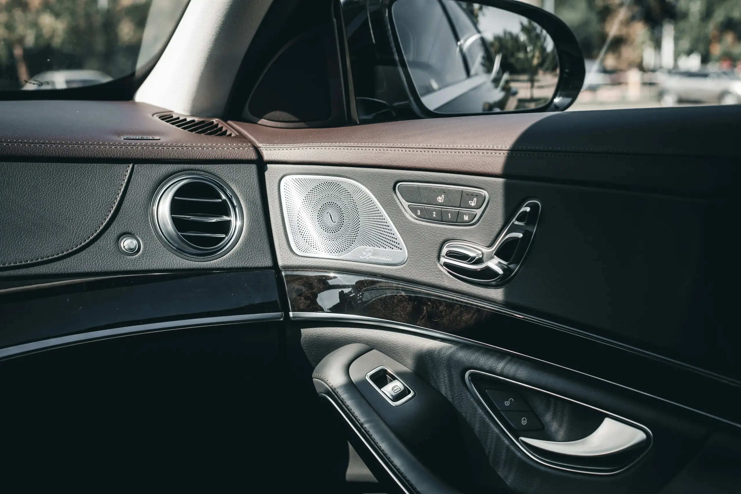 close-up of a chauffeur presenting a printed limousine quote beside a luxury sedan interior, tablet showing itemized pricing, elegant business setting