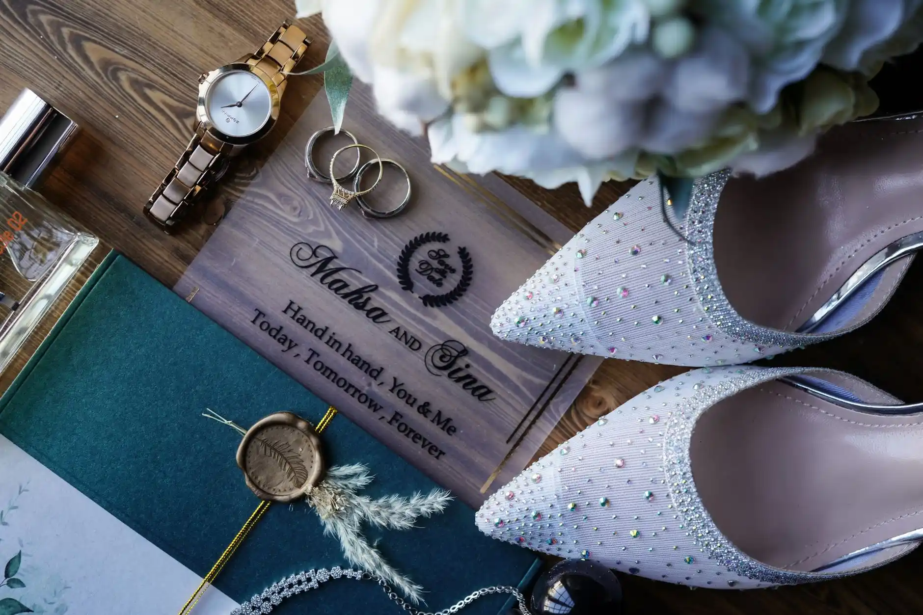 Seattle wedding timeline flat lay with invitation suite, watch, phone map route, chauffeur itinerary, and blush florals on a hotel suite table